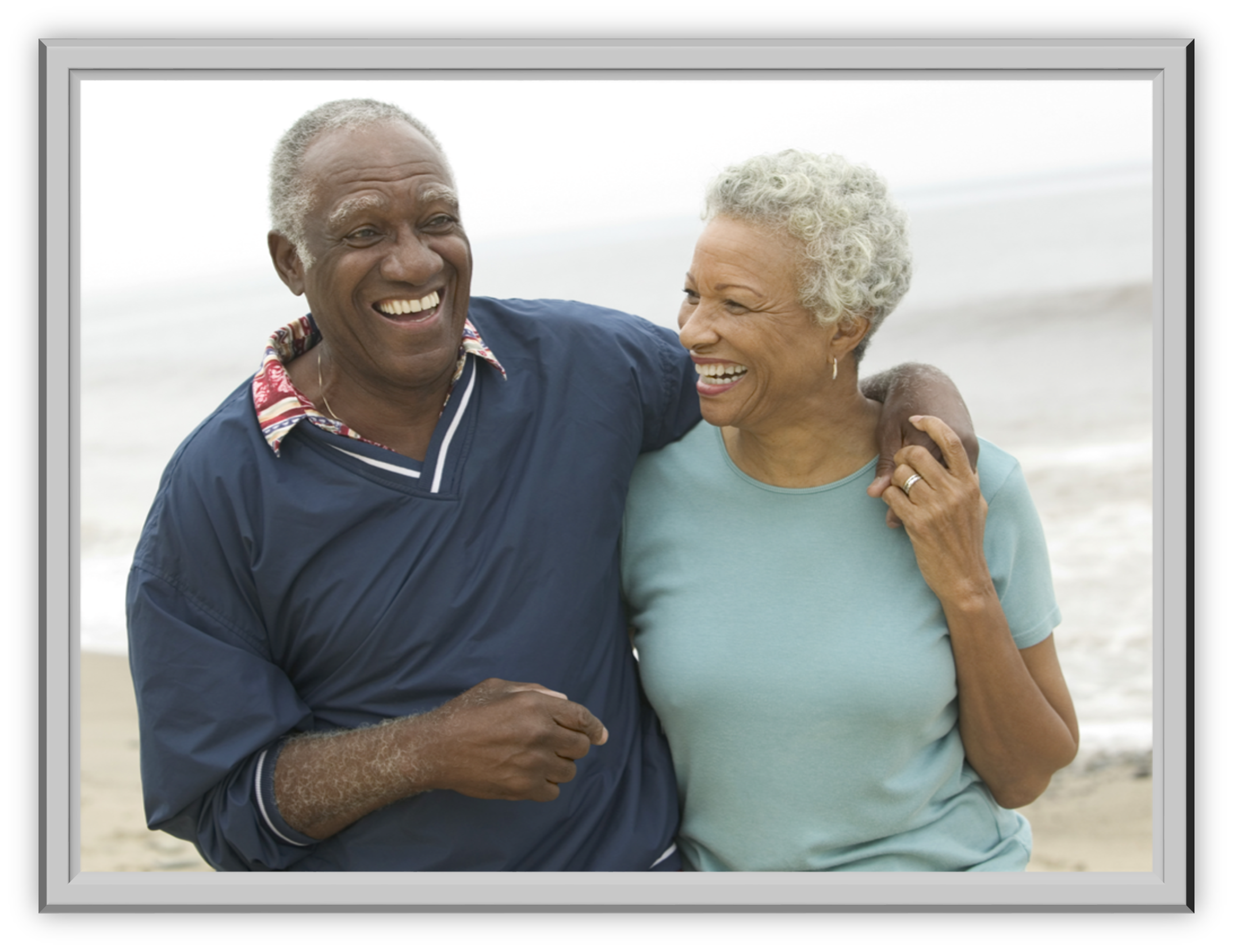 An elderly couple joyfully walking on a beach, arm in arm. Both are smiling warmly, conveying happiness and companionship. Ocean waves in the background.