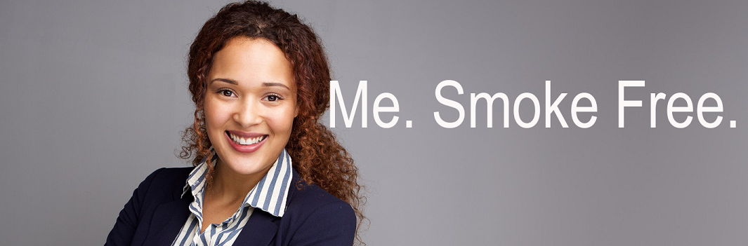 Smiling woman with curly hair in professional attire against a gray background. Text: 'Me. Smoke Free.' Conveys confidence and positivity.