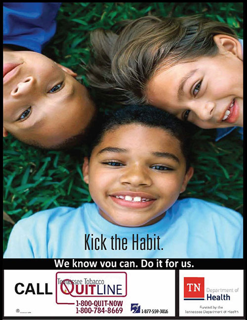 Three children lie on grass smiling up at the camera. Text reads 'Kick the Habit,' promoting the Tennessee Tobacco QuitLine. Tone is hopeful and encouraging.